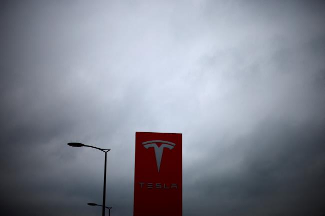 The logo of Tesla is pictured at a dealership in Chambourcy, near Paris, France, December 15, 2021. REUTERS/Go<em></em>nzalo Fuentes