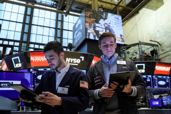 Traders work on the floor of the NYSE in New York