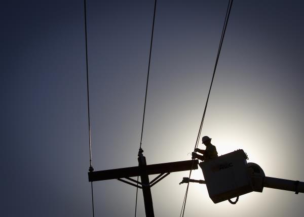 An electrical line technician works on restoring power after tornado Vilonia, Arkansas