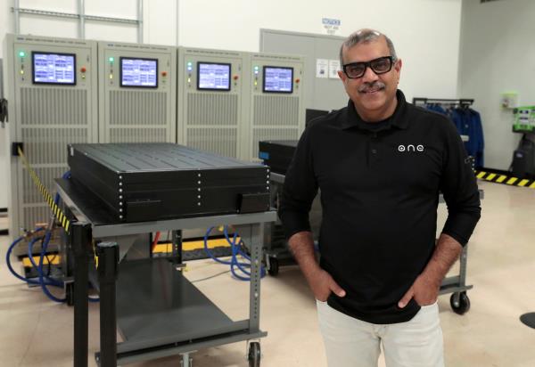 Our Next Energy CEO Mujeeb Ijaz stands next to Aries lithium iron phosphate battery packs waiting to undergo testing at ONE's headquarters in Novi