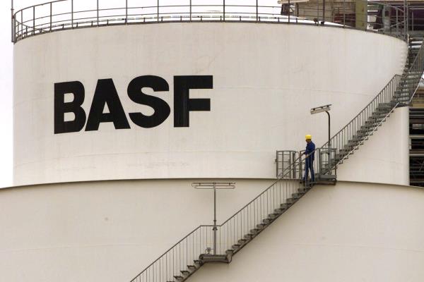 A WORKER WALKS DOWN STAIRS AT BASF CHEMICAL PLANT IN SCHWARZHEIDE.