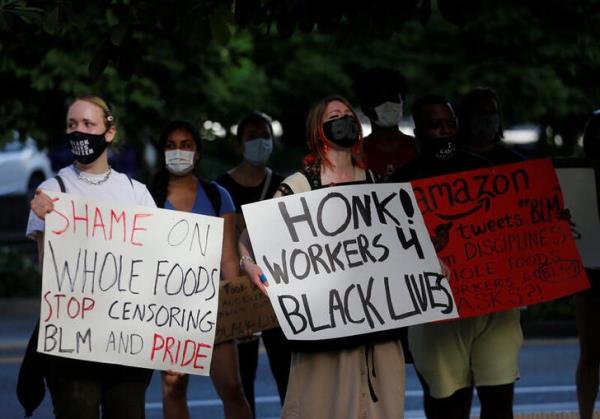 Workers of the South Lake Unio<em></em>n Whole Foods protest against store management not allowing workers to wear Black Lives Matter apparel in Seattle