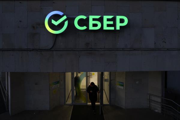 The logo is on display in an office of Sberbank in Saint Petersburg