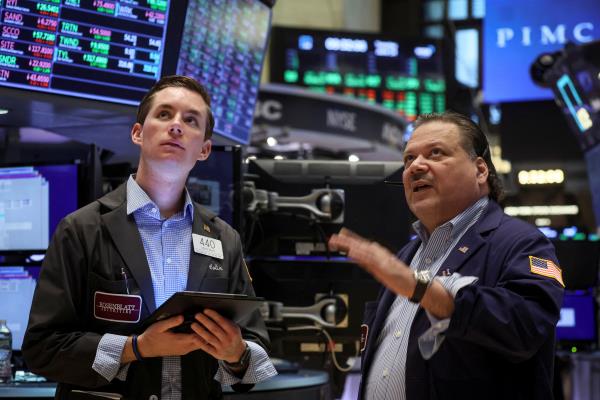 Traders work on the floor of the NYSE in New York