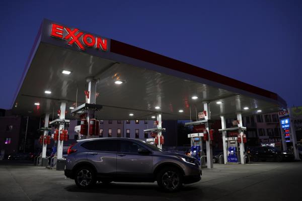 Cars are seen at an Exxon gas station in Brooklyn, New York City