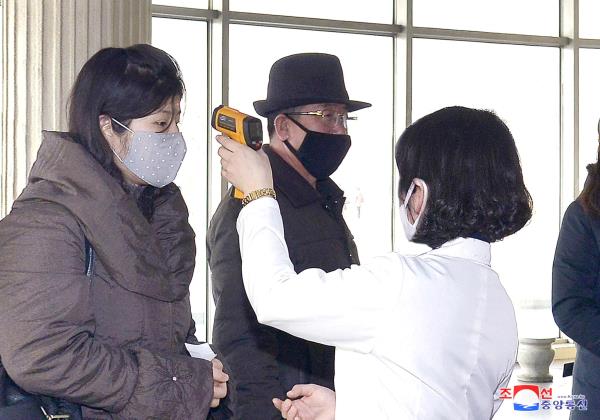 KCNA picture of volunteers carrying out temperature screening during an anti-virus campaign in Pyongyang