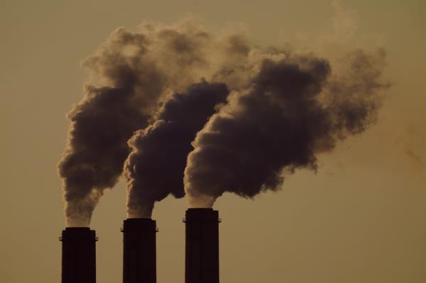 FILE - Emissions rise from the smokestacks at the Jeffrey Energy Center coal power plant as the sun sets, near Emmett, Kan., Sept. 18, 2021.