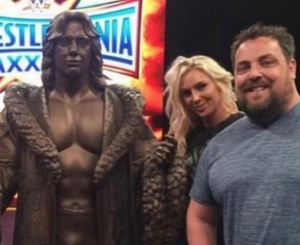 David Flair (right) pictured with his sister Charlotte near a statue of their dad, Ric