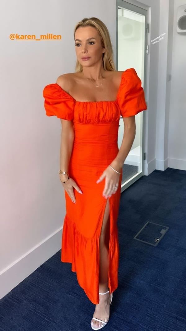 Her tangerine gown featured a thigh-high slit as she paraded her killer curves