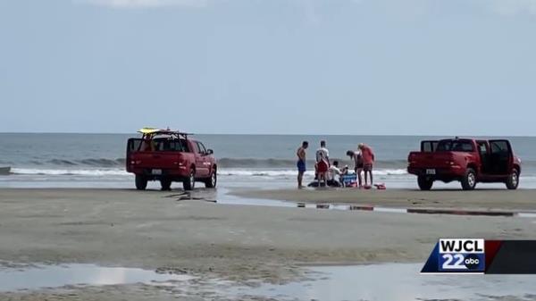 The popular family beach was forced to close after the man had to be dragged out of the water by beach service personnel