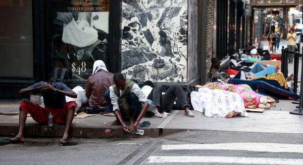 Migrants are seen sleeping outside the Roosevelt Hotel in Midtown Manhattan early Monday, July 31, 2023. 