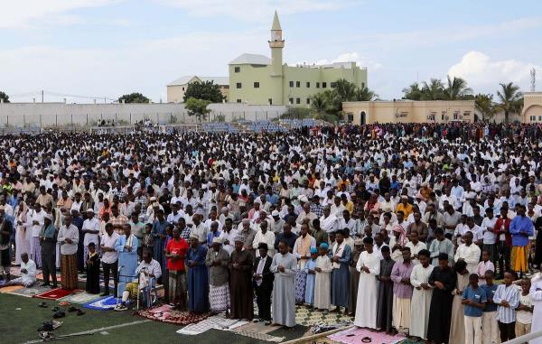 Muslim faithful attend the Eid al-Fitr prayers, marking the end of the holy fasting mo<em></em>nth of Ramadan, at the Hodan district football stadium in Mogadishu, Somalia