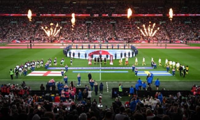 The England and Sweden players take to the pitch at Wembley Stadium in front of 63,248 fans.