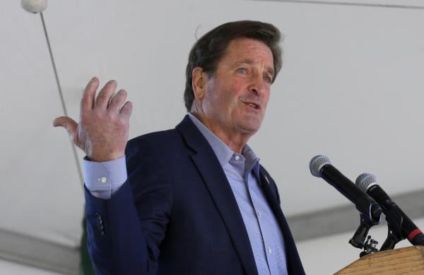 JA man gestures as he speaks at a lectern.