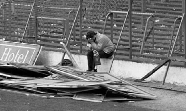 A Liverpool fan sitting pitchside, after the deadly crush.