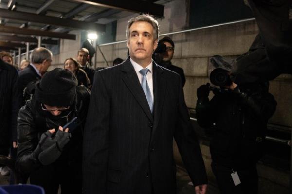 FILE – Michael Cohen, former attorney to Do<em></em>nald Trump, leaves...