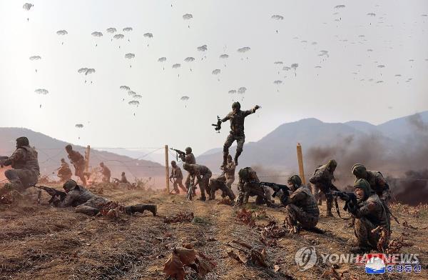 This photo, carried by North Korea's official Korean Central News Agency on March 16, 2024, shows the North staging military drills of paratroopers, guided by its leader Kim Jong-un, the previous day. (For Use o<em></em>nly in the Republic of Korea. No Redistribution) (Yonhap)