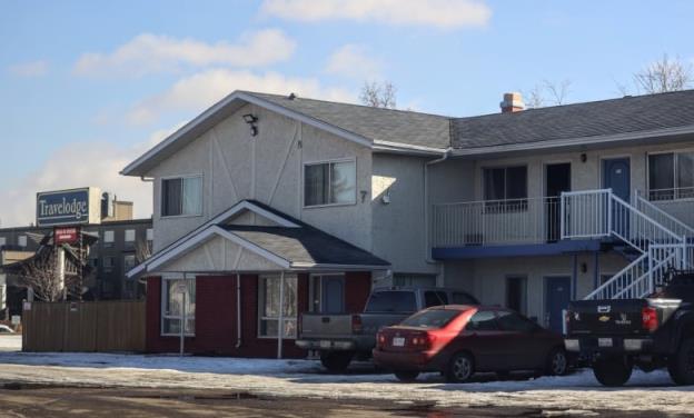 Cars are parked outside a two-storey motel in Leduc, Alberta.