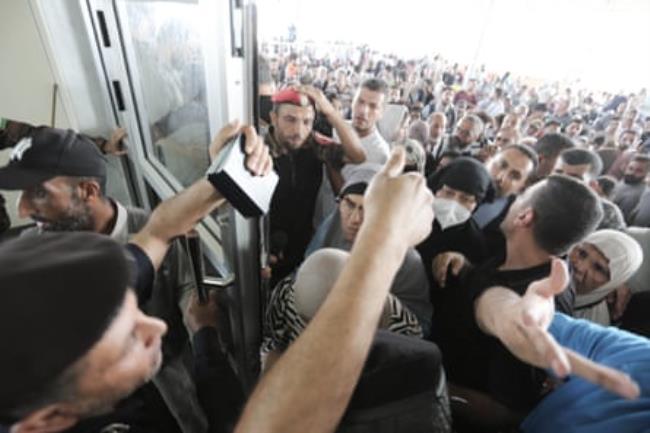 A huge crowd of people walk through a gate to enter the Rafah border crossing to Egypt in the southern Gaza Strip on 1 November 2023.