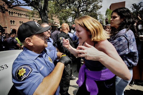 FILE - A University of Southern California protester, right, co<em></em>nfronts a University Public Safety officer at the campus' Alumni Park during a pro-Palestinian occupation, Wednesday, April 24, 2024, in Los Angeles. (AP Photo/Richard Vogel, File)