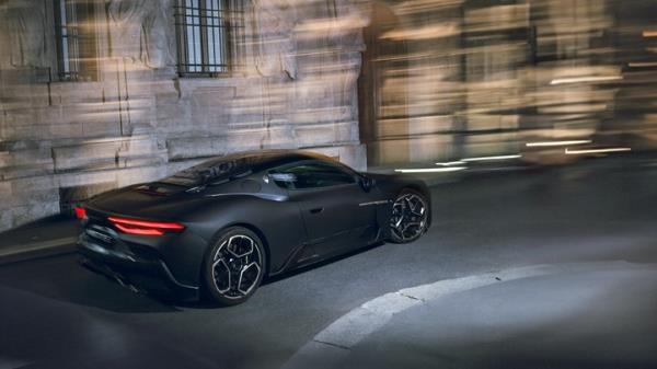 Maserati MC20 Notte: rear three quarter static, black paint, building in background