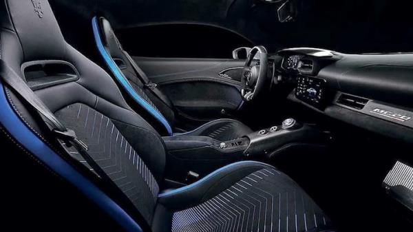 Maserati MC20 Notte: front three quarter static, one door open, black paint