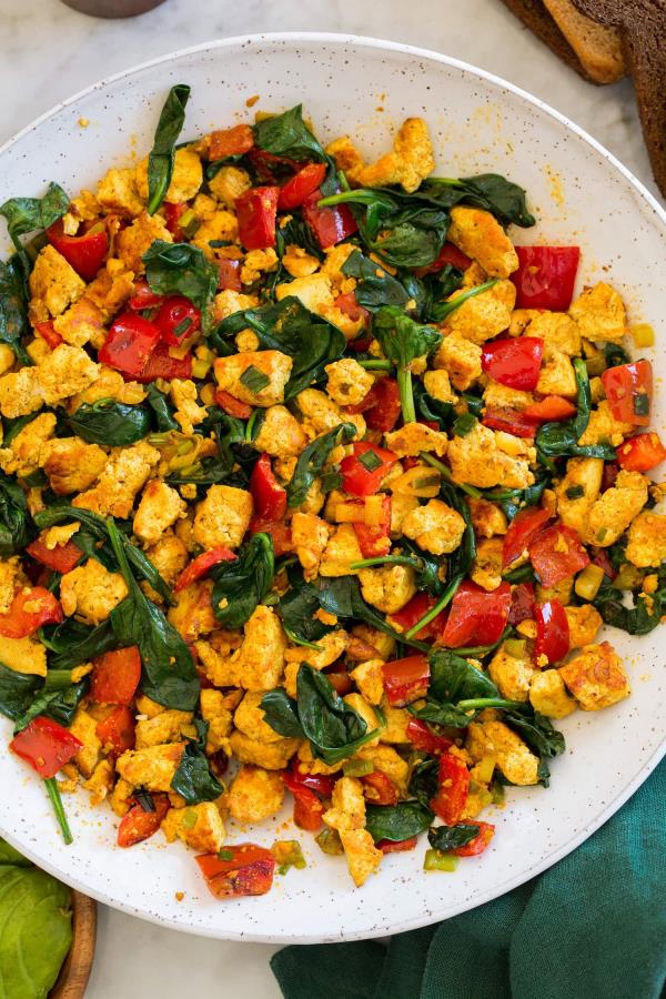 Close up overhead photo of tofu scramble with spinach and bell peppers.