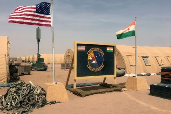 FILE - A U.S. and Niger flag are raised side by side at the ba<em></em>se camp for air forces and other perso<em></em>nnel supporting the co<em></em>nstruction of Niger Air ba<em></em>se 201 in Agadez, Niger, April 16, 2018. The United States is attempting to create a new military agreement with Niger that would allow it to remain in the country, weeks after the junta said its presence was no lo<em></em>nger justified, two Western officials told The Associated Press Friday April 19, 2024. (AP Photo/Carley Petesch, File)