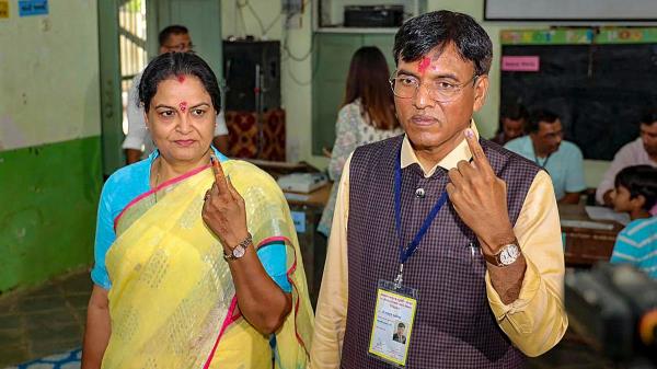 Unio<em></em>n Minister Mansukh L Mandaviya and his wife Neeta show their inked fingers after casting their vote during the third phase of Lok Sabha polls, in Bhavnagar, Gujarat.
