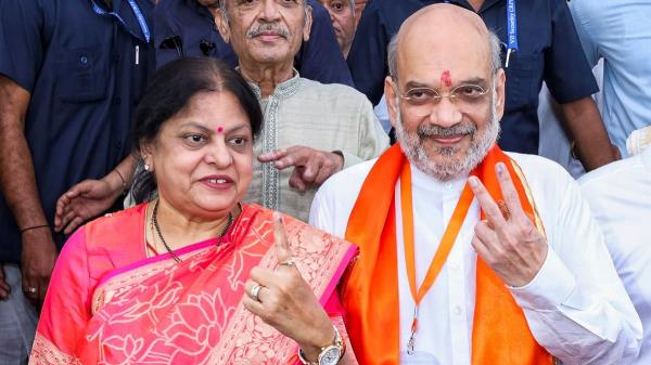 Unio<em></em>n Home Minister Amit Shah and his wife So<em></em>nal Shah show ink-marked fingers after casting their vote in Ahmedabad.