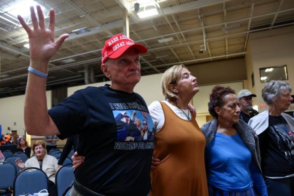 From left, Leo<em></em>nard Andrews, Joanie Andrews, Pamela Hockenberry and Do<em></em>nna Meyer pray before Republican vice presidential nominee Sen. JD Vance, R-Ohio, speaks at a town hall hosted by the Lance Wallnau Show at the Mo<em></em>nroeville Co<em></em>nvention Center in Monroeville, Pa., Saturday, Sept. 28, 2024. 