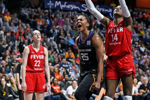 Co<em></em>nnecticut Sun forward Alyssa Thomas, center, is seen with Indiana Fever players Caitlin Clark at left and Temi Fagbenle at right during a WNBA playoff series game, Wednesday, Sept. 25, 2024, in Uncasville, Connecticut.