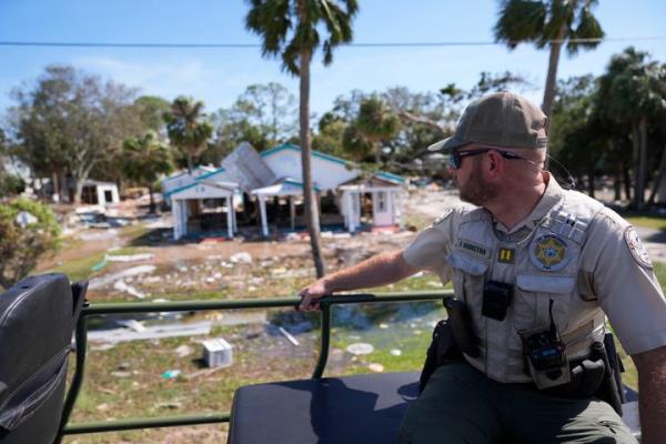 Capt. BJ Johnston, a law enforcement officer from the Florida Fish Wildlife and Co<em></em>nservation Commission surveys destruction from a high water buggy in the aftermath of Hurricane Helene, in Cedar Key, Fla., Friday, Sept. 27, 2024. (AP Photo/Gerald Herbert)