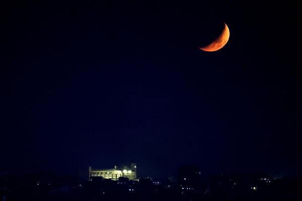 The moon is seen over a building in Beirut southern suburbs, amid the o<em></em>ngoing hostilities between Hezbollah and Israeli forces, as seen from Sin El Fil, Lebanon 