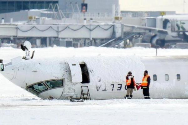 A Delta Air Lines plane lies upside down at Toro<em></em>nto Pearson Airport on Tuesday, Feb. 18, 2025. (Chris Young/The Canadian Press via AP)