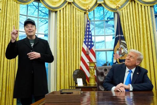 President Do<em></em>nald Trump listens as Elon Musk speaks