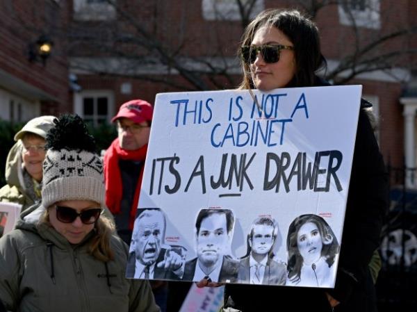 Protesters carry signs. Protesters rally on President's Day at Lawyers Mall in Annapolis against the policies of President Do<em></em>nald Trump and Elon Musk as part of the natio<em></em>nwide "50501" Movement. (Paul W. Gillespie/Staff)