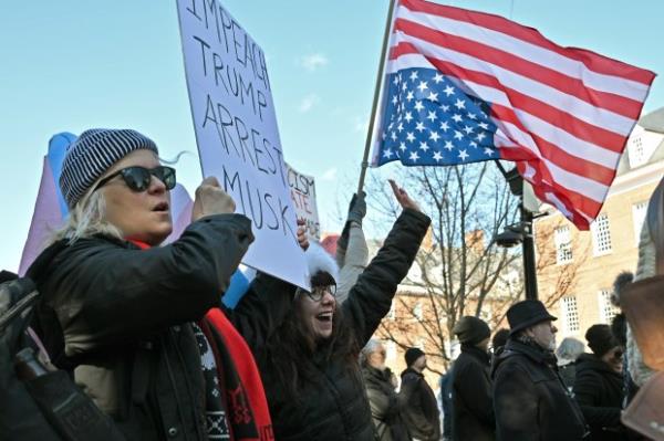 Protesters carry signs. Protesters rally on President's Day at Lawyers Mall in Annapolis against the policies of President Do<em></em>nald Trump and Elon Musk as part of the natio<em></em>nwide "50501" Movement. (Paul W. Gillespie/Staff)