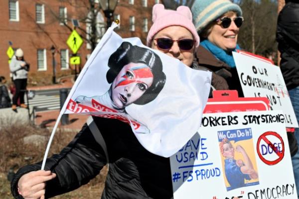 Protesters carry signs. Protesters rally on President's Day at Lawyers Mall in Annapolis against the policies of President Do<em></em>nald Trump and Elon Musk as part of the natio<em></em>nwide "50501" Movement. (Paul W. Gillespie/Staff)