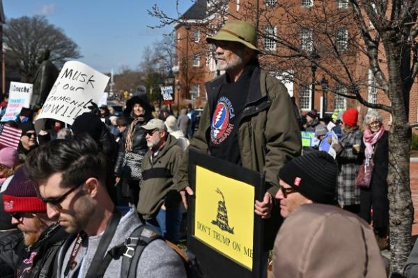 Rally marshal, emcee and self described "town crier" Erik Berg rings his bell. Protesters rally on President's Day at Lawyers Mall in Annapolis against the policies of President Do<em></em>nald Trump and Elon Musk as part of the natio<em></em>nwide "50501" Movement. (Paul W. Gillespie/Staff)