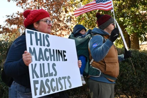 Protesters carry signs. Protesters rally on President's Day at Lawyers Mall in Annapolis against the policies of President Do<em></em>nald Trump and Elon Musk as part of the natio<em></em>nwide "50501" Movement. (Paul W. Gillespie/Staff)